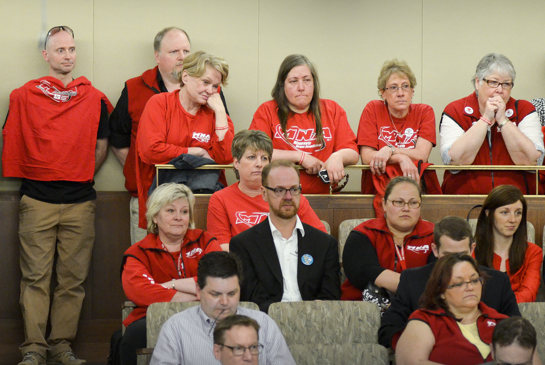 Donning red shirts, members of the Minnesota Nurses Association listen to testimony during the April 16 informational meeting of the House Health and Human Services Finance Committee on HF1654, a bill that would require hospitals to provide staffing levels consistent with nationally accepted standards. Photo by Andrew VonBank